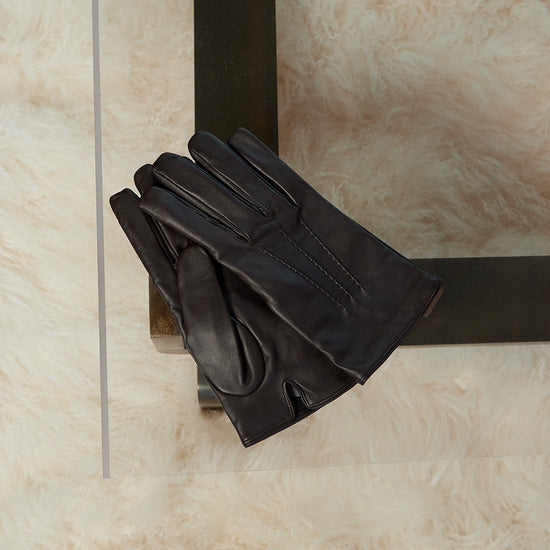 leather gloves on a coffee table