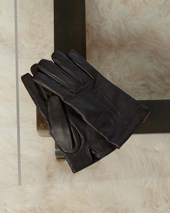 leather gloves on a coffee table